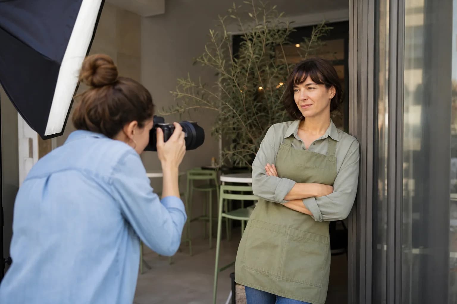 Independent photographer directing a small-business portrait session on location